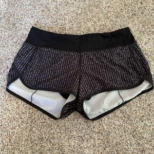 Lululemon Speed Up Short. Size 6. Black with cursive mantra print.